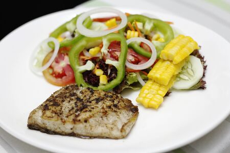 grilled fish with black pepper and saladの写真素材