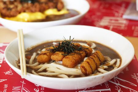 udon curry with  fried fishstickの写真素材
