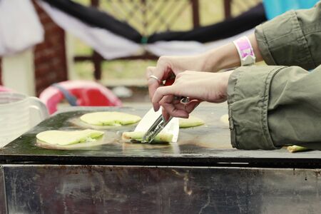 person hand try to roll Thai pandanus pancake,Thai desert styleの写真素材