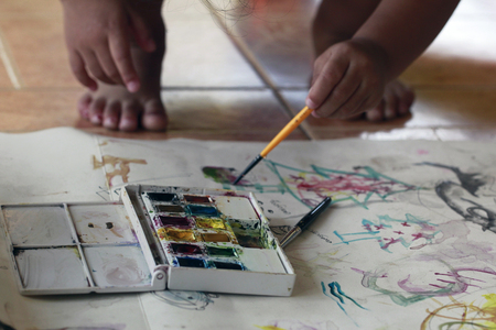 hand of child painting water colorの写真素材