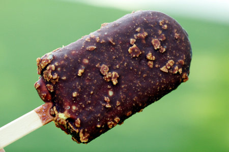 chocolate dipped ice cream on light green background