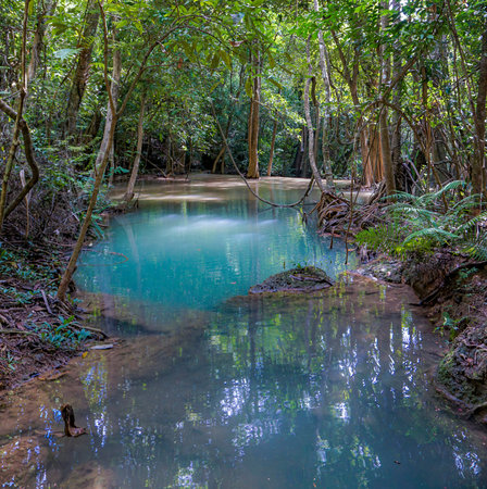 The clean waterfall there is an emerald green colour caused by reflections from trees and lichen circulating through the yellow limestone. Huai Mae Khamin Waterfall, Kanchanaburi Provinceの写真素材