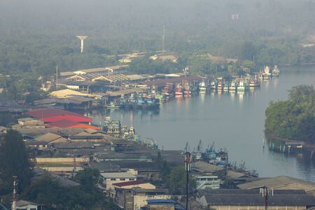 Fishing village Live by the river near the sea Fishing boat docked Waiting out for fish at nightの写真素材