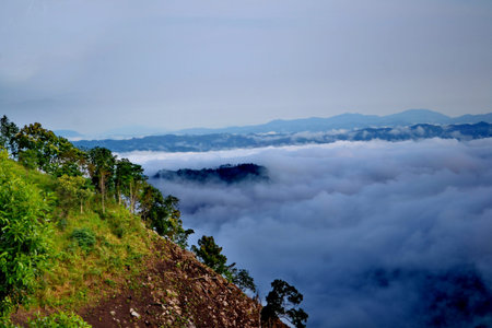 Clouds roll over the volcanic mountaintop during a rainy season
