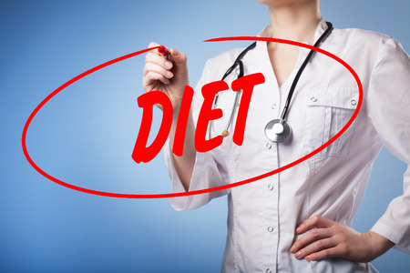 Woman doctor writes a red marker on transparent wipe board Diet.Technology, internet concept,medicineの写真素材
