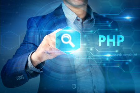 Business, internet, technology concept.Businessman chooses PHP button on a touch screen interface.の写真素材