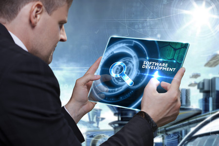 Business, Technology, Internet and network concept. Businessman working on the tablet of the future, select on the virtual display: software developmentの写真素材