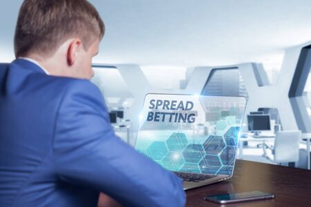 Business, Technology, Internet and network concept. Business man working on the tablet of the future, select on the virtual display:  spread bettingの写真素材