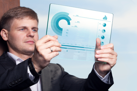 Business Technology Internet and network concept . Young business man working on the tablet of the future select the virtual screenの写真素材