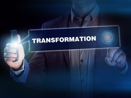 Business internet technology concept. Businessman chooses Transformation button on a touch screen interface.の写真素材