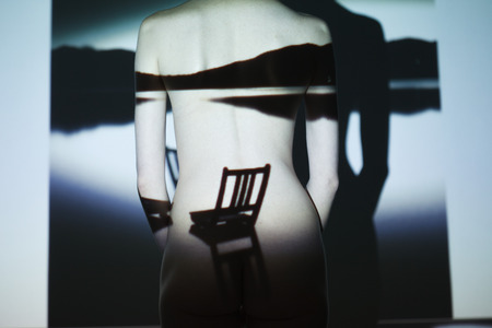 Fashion art studio portrait of elegant naked lady with shadow on her body.の写真素材
