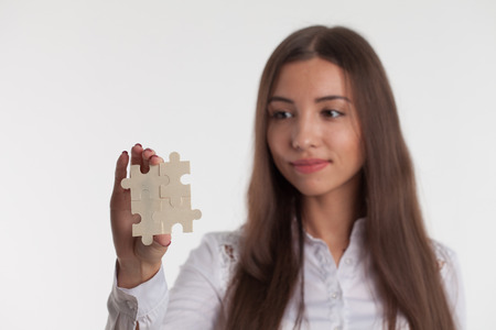 Problem solution concept flat.Man's hand places last detail of puzzle in jigsaw.の写真素材