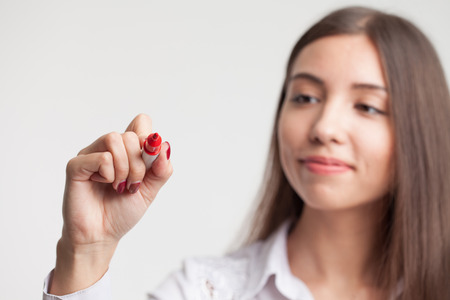 young girl confidently write in the empty space.の写真素材