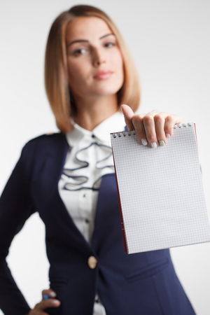 Success in business, job and education concept.Portrait of young beautiful businesswoman with clipboard writing, on white background.の写真素材
