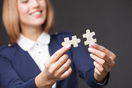 Problem solution concept flat.Man's hand places last detail of puzzle in jigsaw.の写真素材