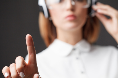 Young businesswoman pressing high tech type of modern buttonsの写真素材