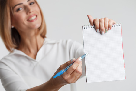 Portrait businesswoman with clipboard writing. Business concept.の写真素材