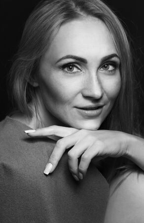 Beauty portrait of a young beautiful brunette girl with long straight flying hair. Magnificent hair. Black and whiteの写真素材
