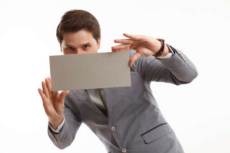 Businessman showing signboard with copyspase, on white.の写真素材