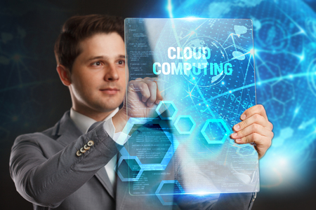 Business, Technology, Internet and network concept. Young businessman showing a word in a virtual tablet of the future:Cloud computingの写真素材