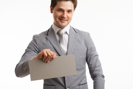 Businessman showing signboard with copyspase, on white.の写真素材