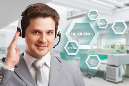 Consulting business concept. Businessman presses text Experience on virtual screen.の写真素材