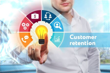 Business, Technology, Internet and network concept. Young businessman shows the word: Customer retentionの写真素材