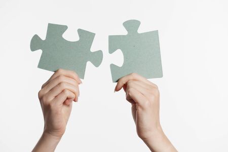 The concept of technology, the Internet and the network. usiness solutions, success and strategy concept. Businessman hand connecting jigsaw puzzle.の写真素材