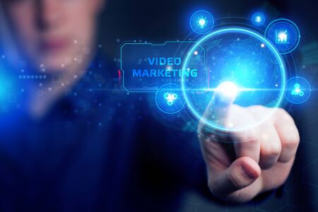 Planning marketing strategy. Business, Technology, Internet and network concept. Young businessman shows the word: Video marketingの写真素材