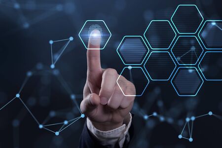 Business, technology, internet and networking concept. Young businessman working  in the office, select the on the virtual display.の写真素材