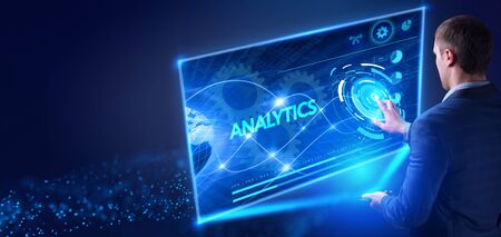 Business, Technology, Internet and network concept. Young businessman working on a virtual screen of the future and sees the inscription: Analyticsの写真素材