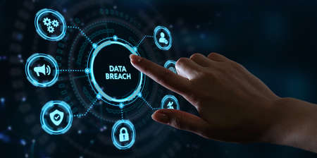 Business, technology, internet and networking concept. Young businessman working on his laptop in the office, select the icon Data breach on the virtual display.の写真素材