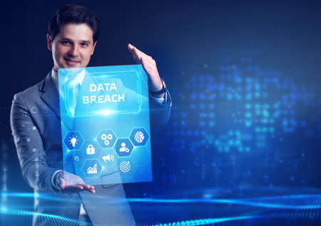 Business, Technology, Internet and network concept. Young businessman shows the word: Data breachの写真素材