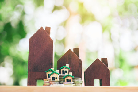 The house placed on a coin is like a village or condo. planning savings money of coins to buy a home concept, concept for property ladder, mortgage and real estate investment or saving  for a house.の写真素材