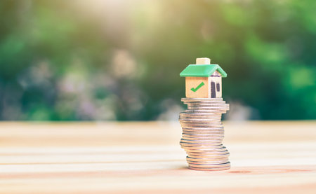 Mortgage and loan approved concept:  house on a coin pile. planning savings money of coins to buy a home concept for property ladder, mortgage and real estate invest. saving or investment for a house,の写真素材