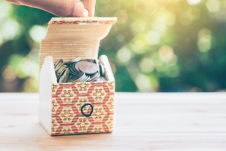Men are opening a box or treasure box to see their own property. planning savings money of coins to buy a home concept concept for property, mortgage and real estate investment. saving for a house.の写真素材