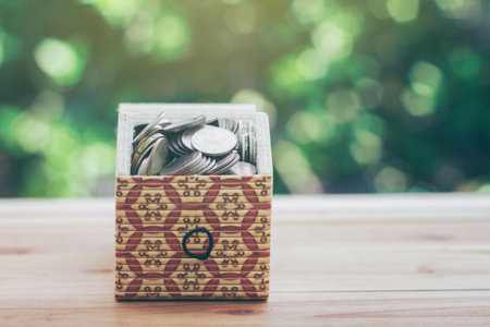 Coins in Treasure Chest indicate savings to buy a home and business growth. planning savings money of coins to buy a home concept for property, mortgage and real estate investment. saving for a house.の写真素材