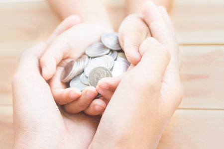 Home loan, home insurance, family life assurance protection, financial mortgage for house building, and legacy planning investment concept with children - parent's hands holding private propertyの写真素材