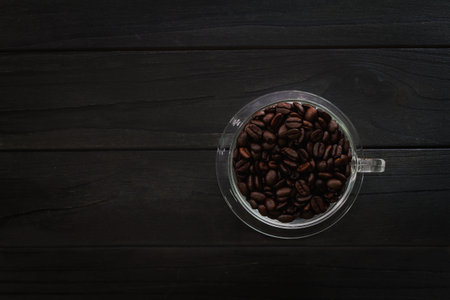 Hot coffee cup  and beans coffee organic on old kitchen table. Top view with copy space for your text.の写真素材