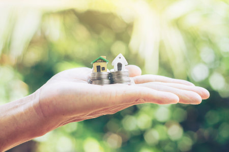 Home loan, home insurance, family life assurance protection, financial mortgage for house building, and legacy planning investment concept with children - parent's hands holding private propertyの写真素材