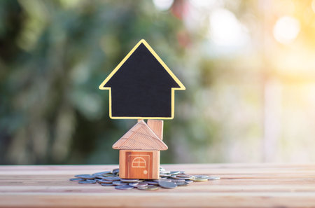 House signs and model houses are placed on coins. indicating the growth of the savings business to buy a house. planning for property, mortgage and real estate investment for saving or  for house.の写真素材
