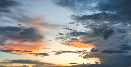 blur The vast Beautiful sky and four orange clouds that are beautiful sky before sunset. The natural sky before background has a breeze on a bright day in the summer.の写真素材