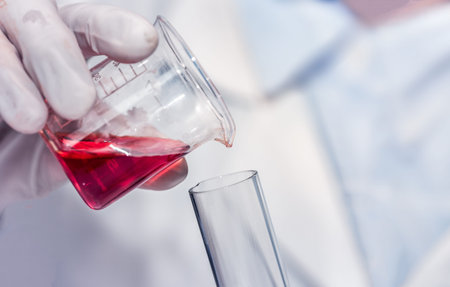 scientist with equipment and science experiments laboratory glassware containing chemical liquid....