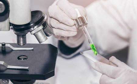 scientist with equipment and science experiments laboratory glassware containing chemical liquid....