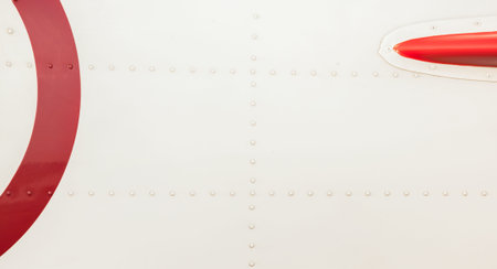 Silver metal surface of the aircraft fuselage with rivets. Fuselage detail view. Airplane metallic...