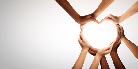 Unity and diversity are at the heart of a diverse group of people connected together as a supportive symbol that represents a sense of and togetherness. Symbol and shape created from hands.の写真素材