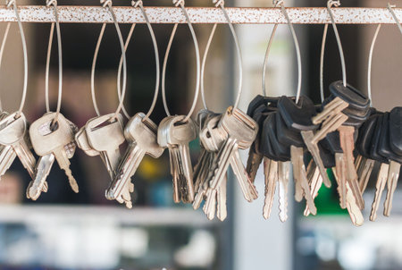A conceptual image with hanging keys and one shining key. Many key chains for copy key on locksmith...