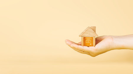 Home loan, home insurance, family life assurance protection, financial mortgage for house building, and legacy planning investment concept with children - parent's hands holding private propertyの写真素材