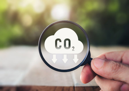 CO2 emission concept. Green industries business concept. Net zero emissions. Magnifying glass with...