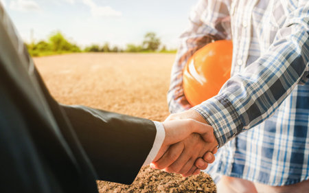 Business handshake land purchase. Businessman handshake a deal with a realtor for the construction...